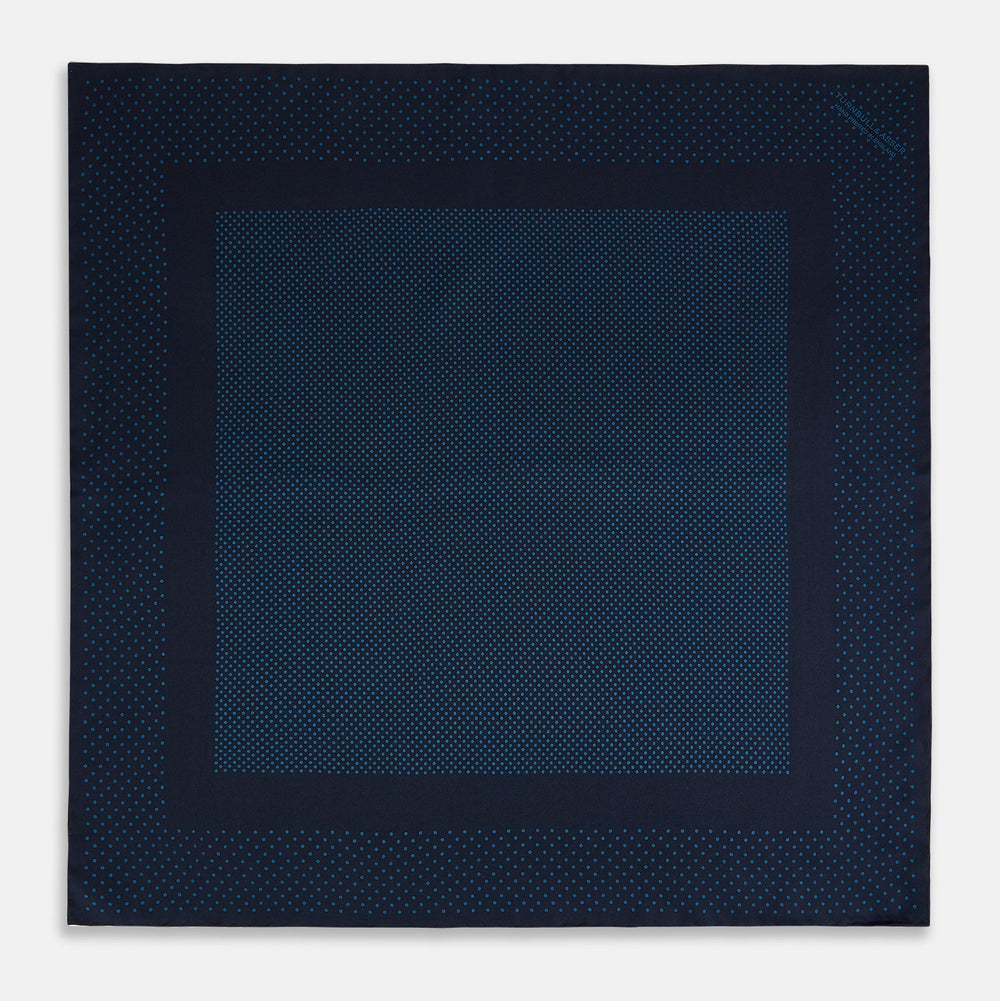 The Turnbull & Asser Navy and Blue Dot Silk Pocket Square features a handmade design in navy silk with small light blue dots and a crisp border, finished with one corner folded to display the reverse side.