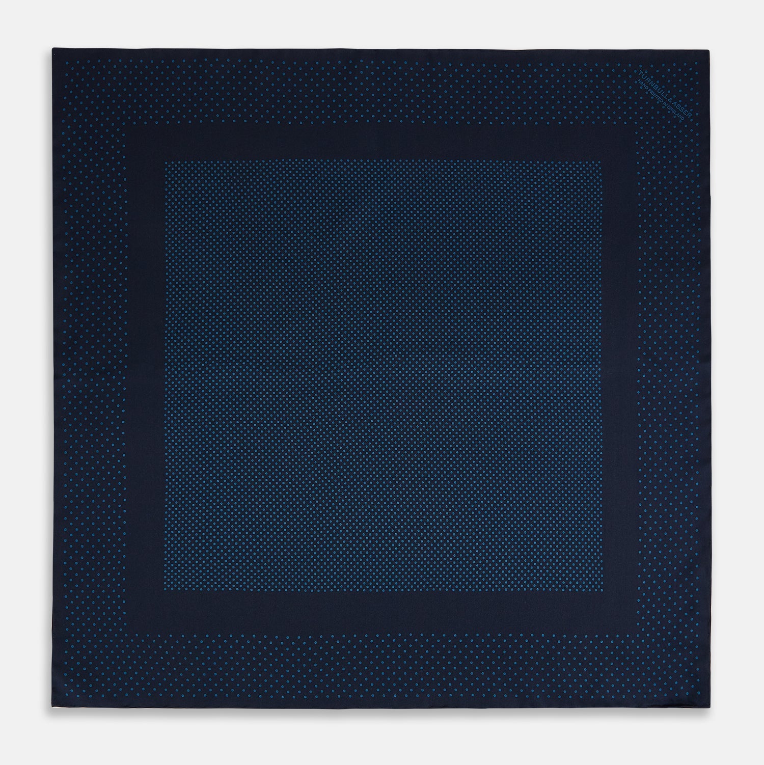 View 4 of product The Turnbull & Asser Navy and Blue Dot Silk Pocket Square features a handmade design in navy silk with small light blue dots and a crisp border, finished with one corner folded to display the reverse side.