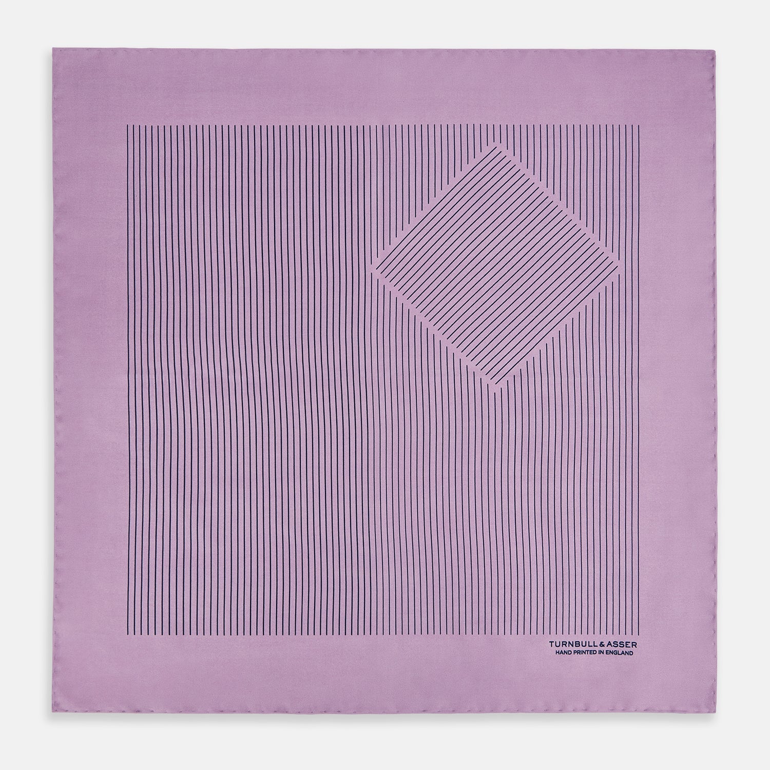 View 3 of product The Lilac Stripe Silk Pocket Square by Turnbull & Asser features thin vertical navy stripes on folded silk, with "TURNBULL & ASSER HAND PRINTED IN ENGLAND" inscribed in the bottom right corner, reflecting British heritage.