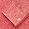 View 3 of product The Turnbull & Asser Pink Linen Weekend Fit Hayne Shirt is a casual, long-sleeve button-down with a subtle texture and white buttons, neatly laid flat on a white background.