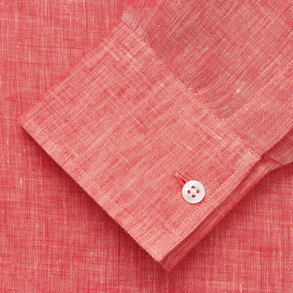 The Turnbull & Asser Pink Linen Weekend Fit Hayne Shirt is a casual, long-sleeve button-down with a subtle texture and white buttons, neatly laid flat on a white background.