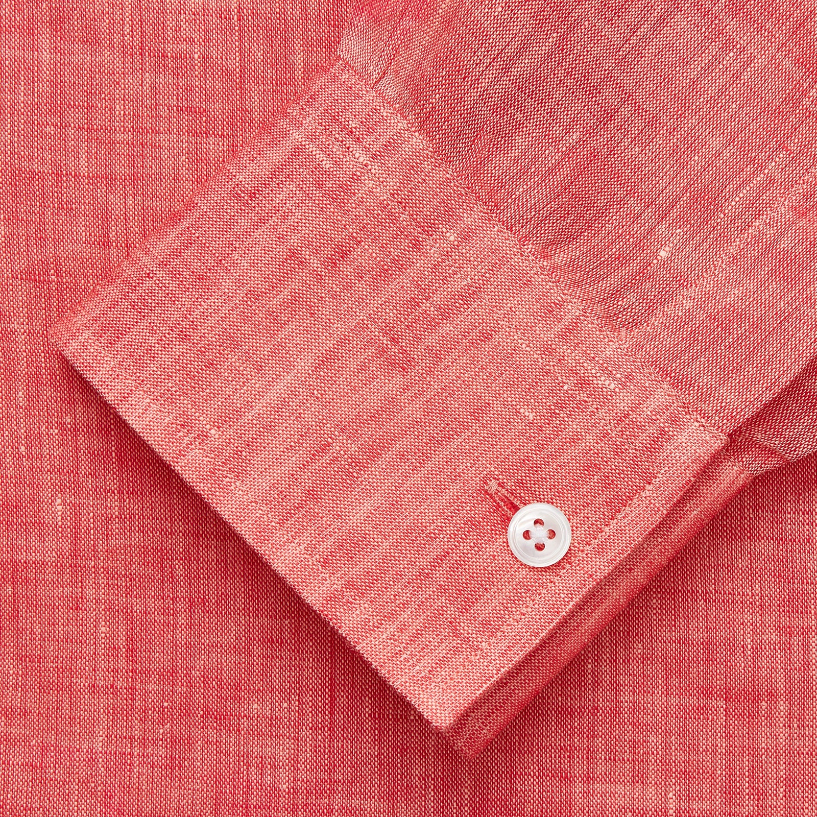 View 3 of product The Turnbull & Asser Pink Linen Weekend Fit Hayne Shirt is a casual, long-sleeve button-down with a subtle texture and white buttons, neatly laid flat on a white background.