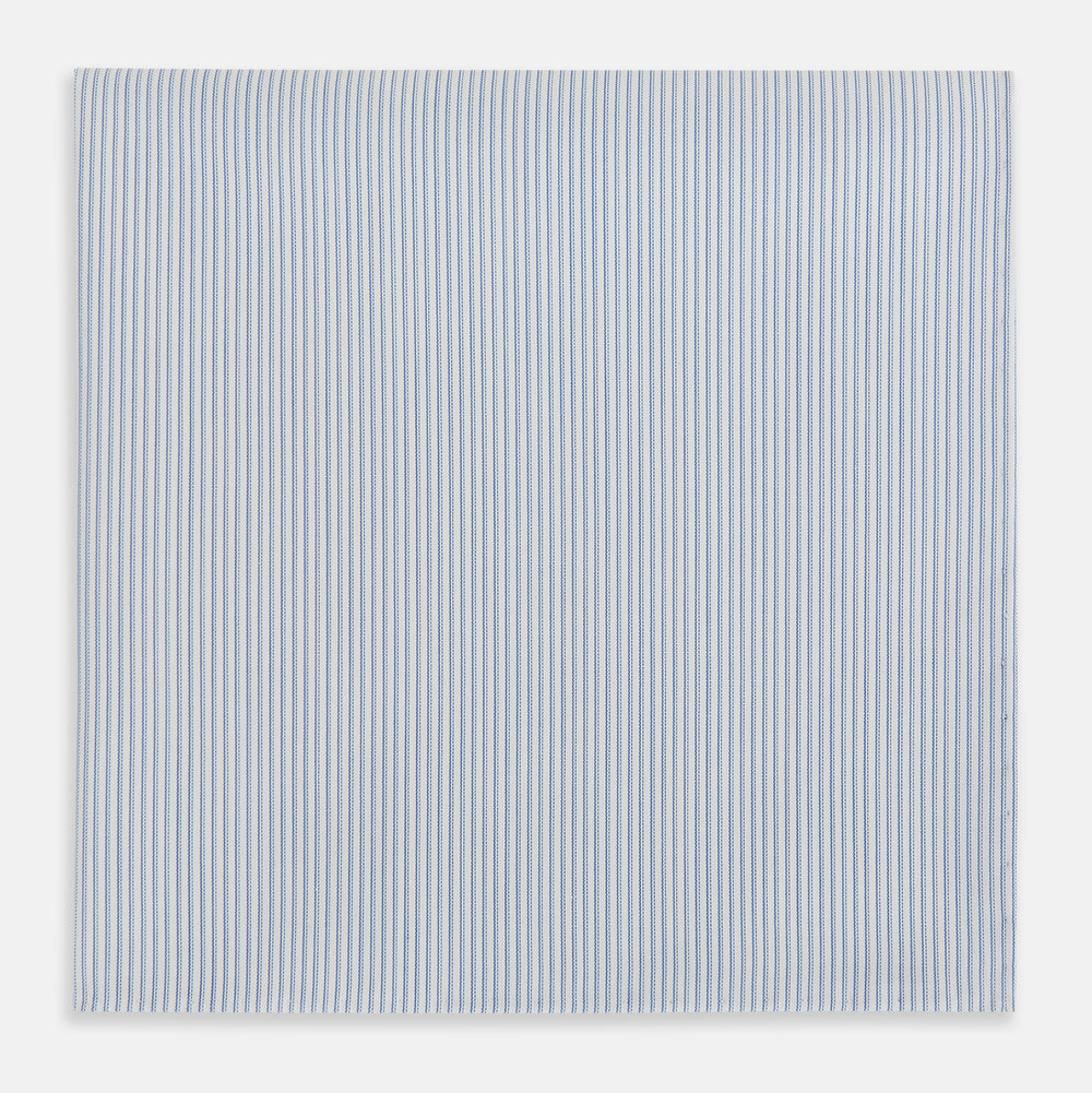 The Turnbull & Asser Sky Blue Hairline Stripe Hand-Rolled Handkerchief, featuring thin blue and white stripes and hand-rolled edges, is displayed flat on a white background.