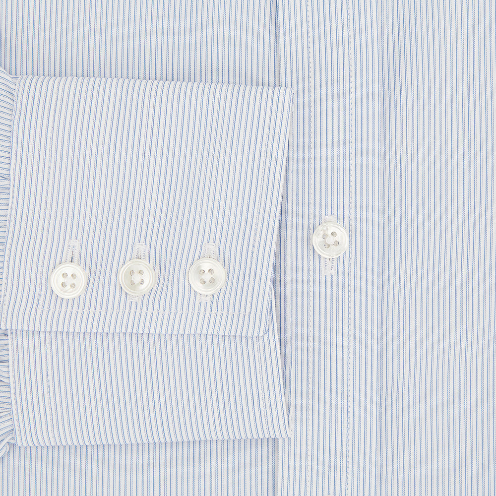 The Turnbull & Asser Sky Blue Hairline Multi Stripe Mayfair Shirt features Italian cotton, long sleeves, a classic collar, white buttons, and a subtle stripe pattern, shown on a plain white background.