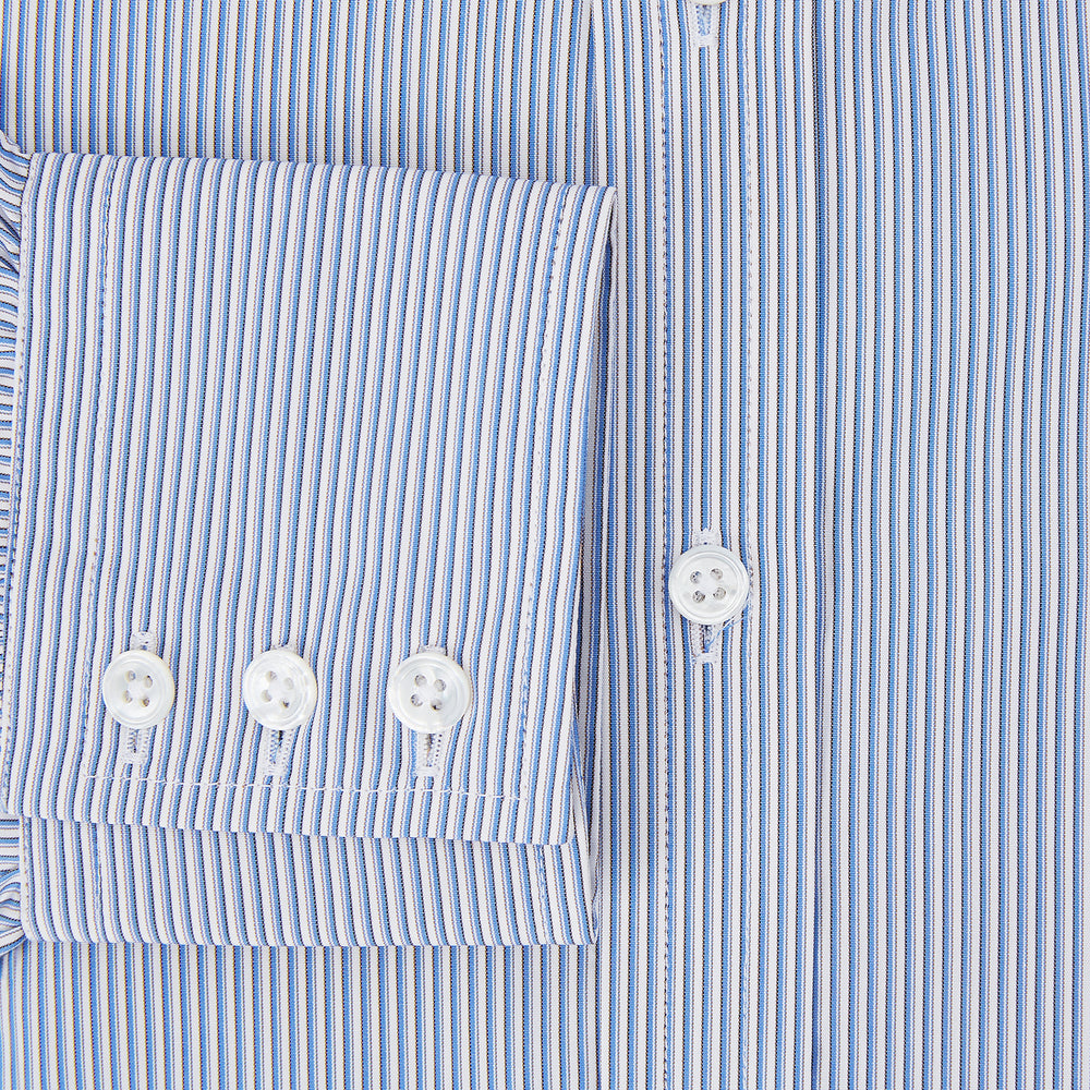 The Turnbull & Asser Pale Blue Pinstripe Mayfair Shirt features pale blue pinstripes, a classic T&A collar, white buttons, and cuffed sleeves, shown against a plain white background.