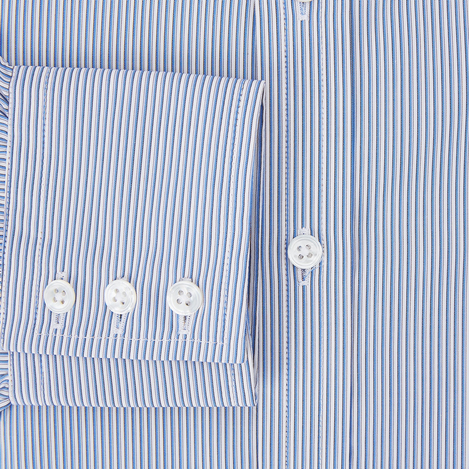 View 4 of product The Turnbull & Asser Pale Blue Pinstripe Mayfair Shirt features pale blue pinstripes, a classic T&A collar, white buttons, and cuffed sleeves, shown against a plain white background.
