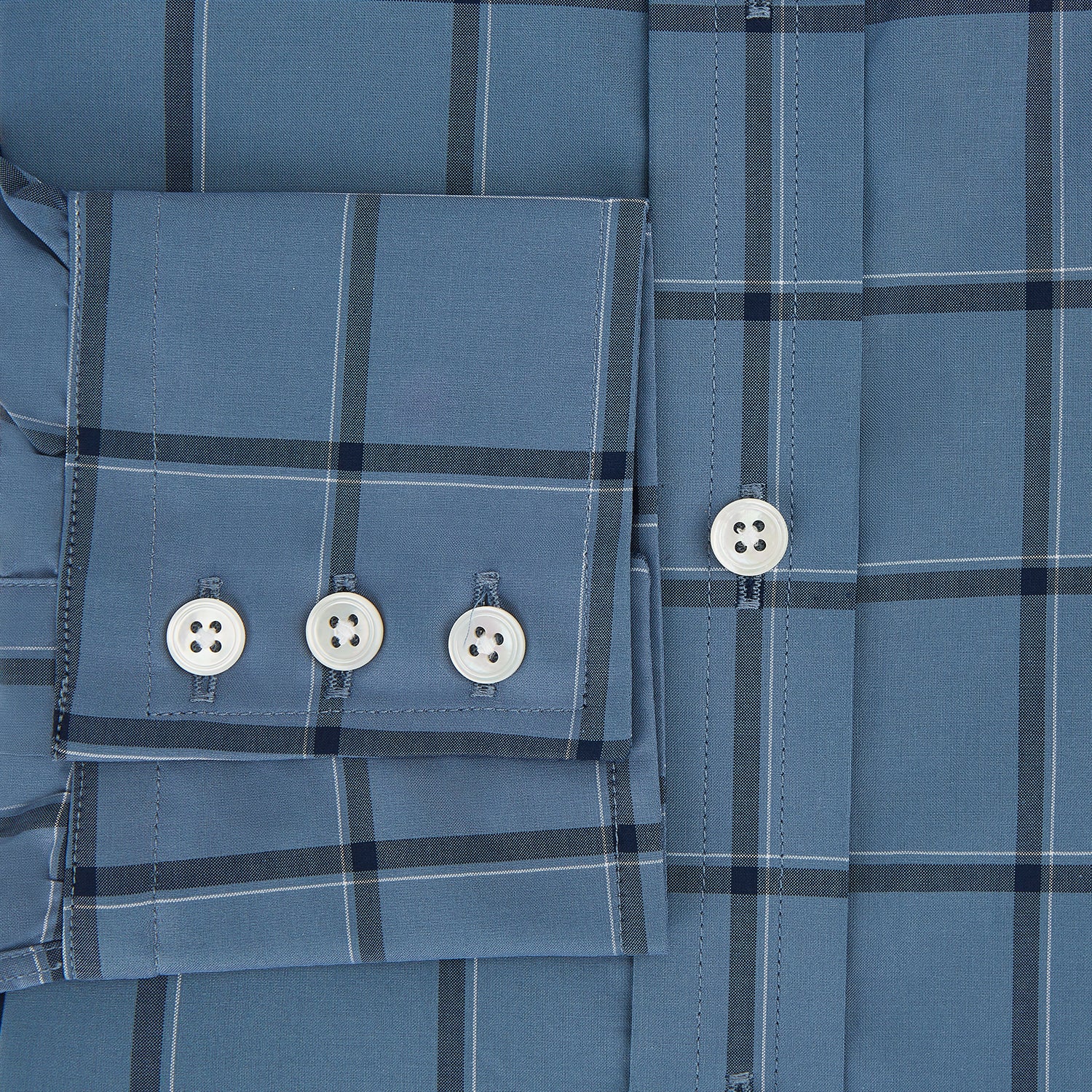 View 4 of product The Turnbull & Asser Steel Grey Grid Check Mayfair Shirt is a long-sleeve, button-up shirt in light blue Italian cotton, shown against a plain white background.