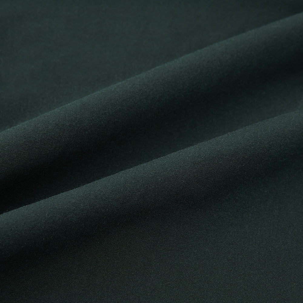 The Hunter Green Winston Trousers by Turnbull & Asser are crafted in high-twist cotton with straight legs, belt loops, button closure, and front zipper, shown against a plain light background.