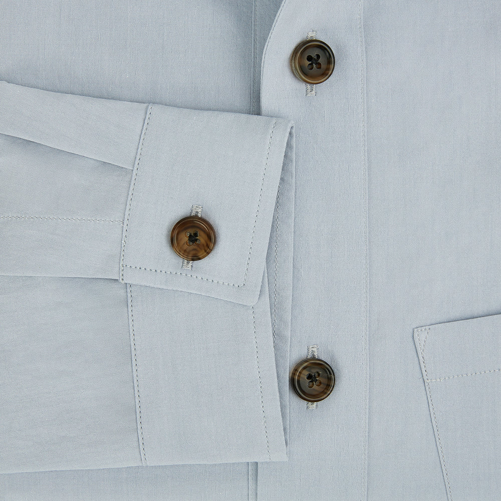 The Turnbull & Asser Grey Hyde Overshirt is a long-sleeve button-up made from sanforised cotton, featuring a single chest pocket and dark buttons, shown against a plain white background.