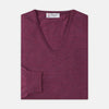 View 4 of product The Turnbull & Asser Plum Fine Merino V-Neck Jumper is a lightweight, long-sleeved layer in deep burgundy, featuring ribbed cuffs and hem for a refined finish, displayed against a white background.
