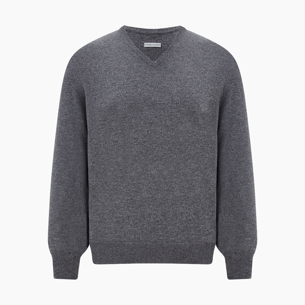 The Turnbull & Asser Storm Grey Cashmere V-neck Jumper features long sleeves, ribbed cuffs and hem—versatile knitwear shown on a white backdrop.