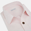 View 2 of product The Soft Pink Hyde Overshirt by Turnbull & Asser features long sleeves, sanforised cotton, dark buttons, and a left front pocket, shown laid flat on a white background.