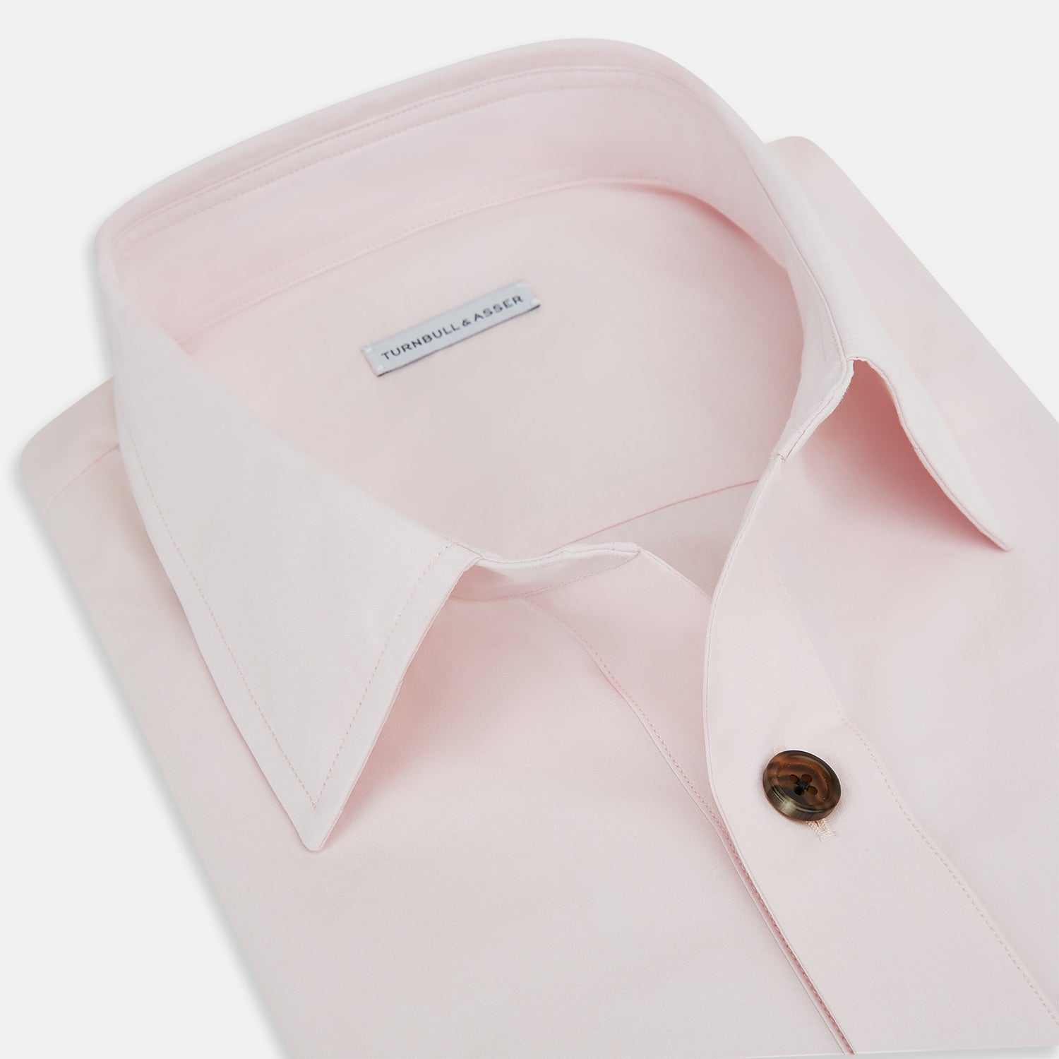 View 2 of product The Soft Pink Hyde Overshirt by Turnbull & Asser features long sleeves, sanforised cotton, dark buttons, and a left front pocket, shown laid flat on a white background.