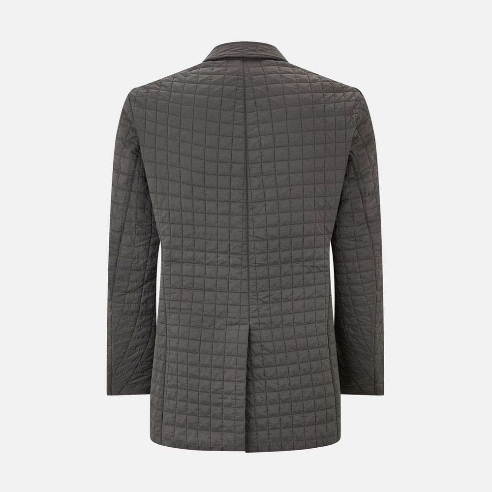 The Fulham Shadow Grey Single-Breasted Quilted Blazer by Turnbull & Asser features a checkered pattern, notched lapel, three front buttons, chest pocket, and two flap pockets—ideal for formal wear on a plain white background.