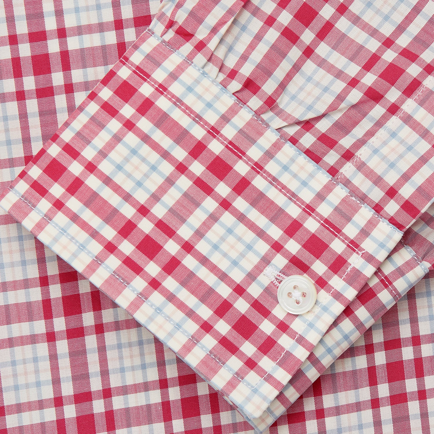 View 4 of product The Turnbull & Asser Red Check Cotton Weekend Fit Finch Shirt is a men's long-sleeved, button-up shirt with a Derby collar and red-and-white plaid pattern, displayed flat on a white background.