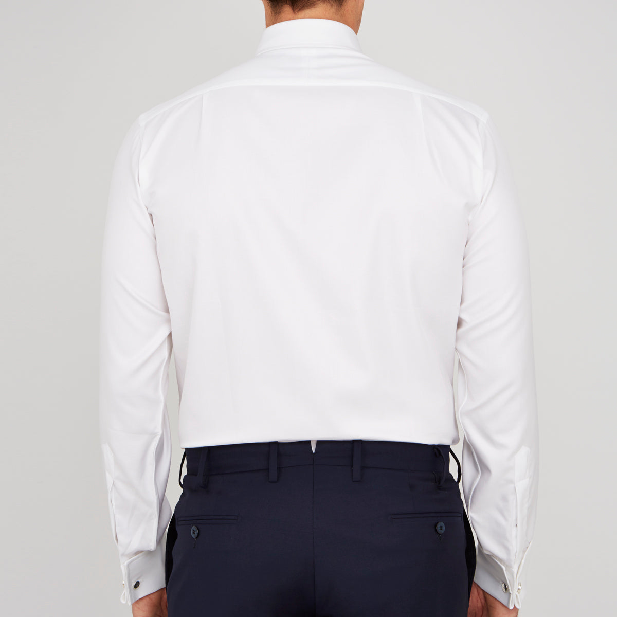 View 3 of product A neatly folded Turnbull & Asser White Oxford Shirt with T&A collar and double cuffs is displayed on a light blue background.