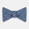 View 1 of product The Azzurro Flower Patterned Silk Bow Tie by Turnbull & Asser features small white flowers on blue silk, creating a refined accessory for smart attire. Shown against a white background.