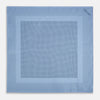 View 4 of product The Turnbull & Asser Pale Blue Dot Silk Pocket Square features pure silk in pale blue with a border and scattered small navy polka dots, neatly folded with one corner turned down.