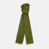 View 1 of product The Moss Green Cashmere Scarf by Turnbull & Asser features a lightweight, slightly sheer texture with subtle unfinished fringe ends. Loosely folded and draping elegantly, it’s a true luxury accessory set against a plain white background.