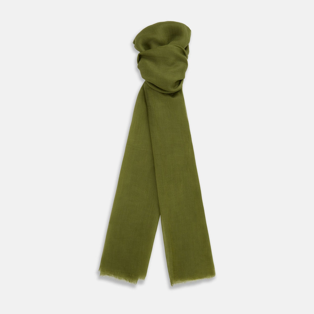 The Moss Green Cashmere Scarf by Turnbull & Asser features a lightweight, slightly sheer texture with subtle unfinished fringe ends. Loosely folded and draping elegantly, it’s a true luxury accessory set against a plain white background.