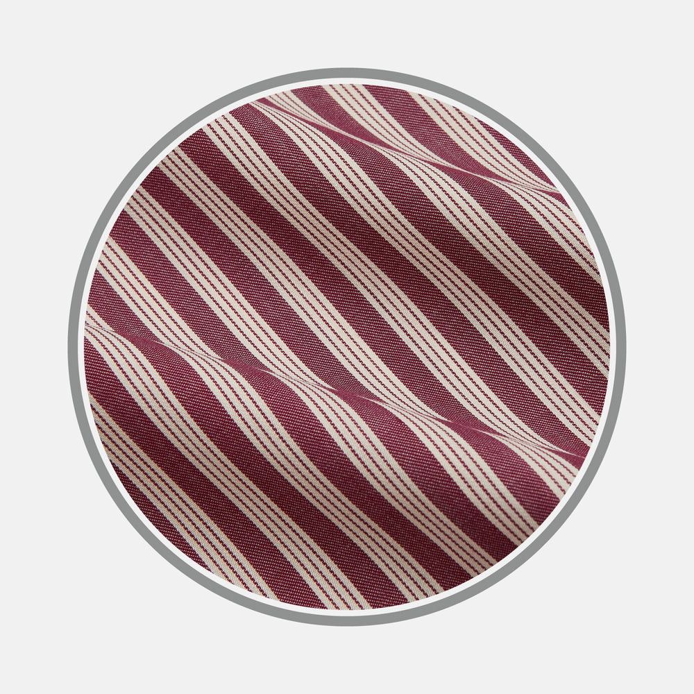 Close-up of Turnbull & Asser's Burgundy Multi Stripe Wool Fabric, featuring diagonal maroon and white stripes, shown within a circular frame on a light gray background.