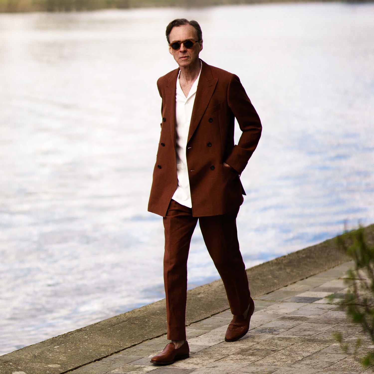View 4 of product Turnbull & Asser’s Rust Linen-Wool-Silk Gerry Trousers, in a classic fit with straight legs, pleats, belt loops, and front button-zip closure, are neatly displayed flat on a white background.