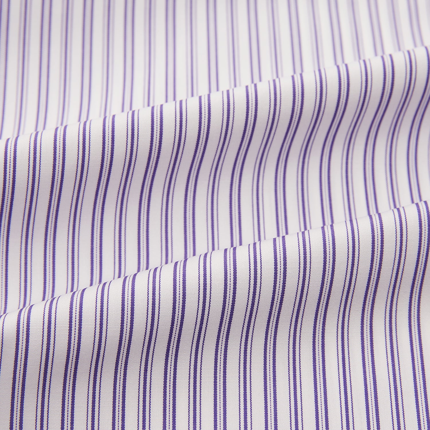 View 6 of product The Turnbull & Asser Purple Ticking Stripe Mayfair Shirt is a long-sleeve button-up with a T&A collar and slim blue-and-white vertical stripes, shown on a white background.