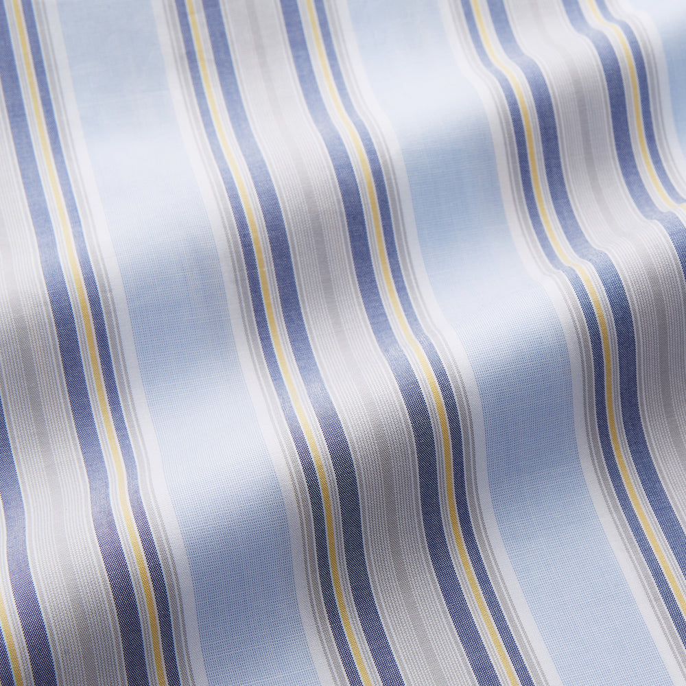The Pale Blue and Yellow Multi Stripe Cotton Sussex Nightshirt by Turnbull & Asser features long sleeves, a knee-length cut, a collar, button-down front, chest pocket, and rounded hem.