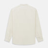 View 5 of product The Turnbull & Asser Cream Cotton Weekend Fit Unwin Shirt features long sleeves, a stand collar, and two chest pockets, shown laid flat on a white background.