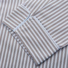 View 2 of product The Turnbull & Asser Pale Blue Multi Stripe Cotton Quin Pyjamas, featuring a long-sleeve button-up top and matching adjustable tie-waist pants, are neatly arranged on a white background.