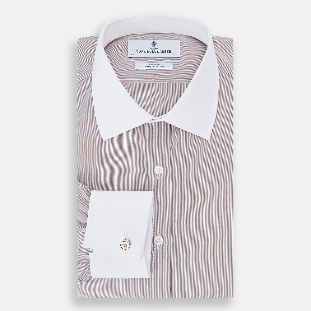 A Turnbull & Asser Burgundy Hairline Stripe Shirt with a contrast white collar and double cuffs, showcasing a tailored fit and button-down front, displayed against a plain white background.