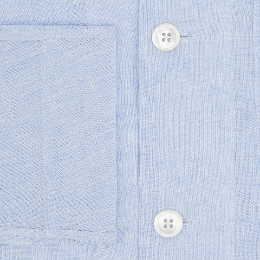 The Turnbull & Asser Pale Blue Linen Pyjama Shirt features long sleeves, a collar, front buttons, and a chest pocket—perfect as elegant loungewear or nightwear.