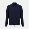 View 1 of product The Turnbull & Asser Navy High Neck Merino Zipped Cardigan is a long-sleeve knit with ribbed mock neck, cuffs, and hem, shown on a plain white background.