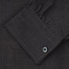View 4 of product A man with short hair wears the Turnbull & Asser Black Check Weekend Fit Flannel Shirt with Derby Collar and 1-Button Cuffs, paired with light pants, against a plain background—ideal for a smart-casual weekend look.