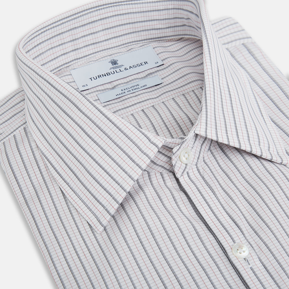 A red and navy graph check Westminster shirt by Turnbull & Asser with a formal collar and tailored fit, featuring a button-up front and buttoned cuffs, laid flat on a white background.