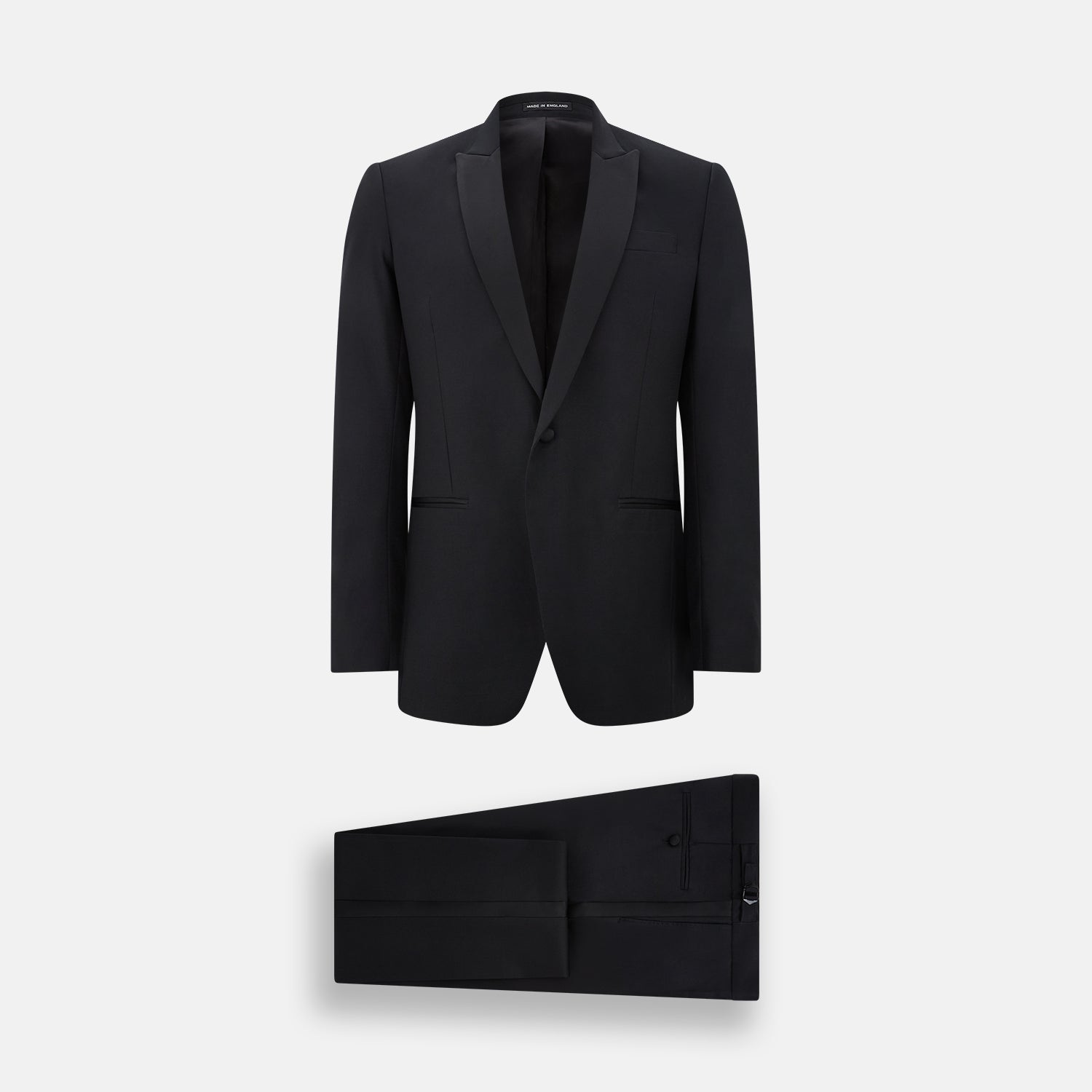View 1 of product The Turnbull & Asser Black Single Breasted Dinner Suit features fine wool, a satin shawl collar jacket, and matching trousers—perfect formal wear, shown on a plain white background.