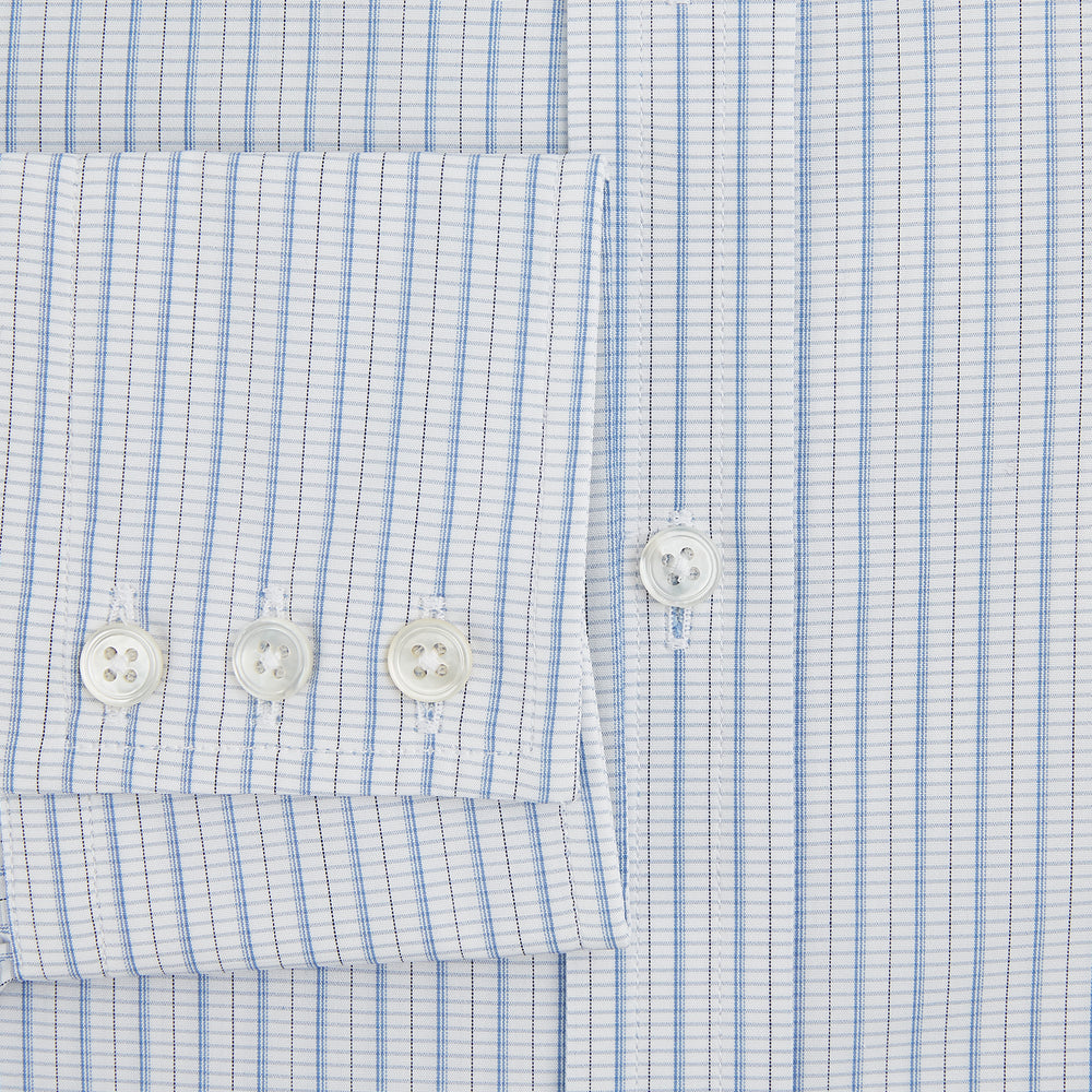 The Turnbull & Asser Blue Graph Check Mayfair Shirt features a classic T&A collar, Mayfair fit, buttoned cuffs, and long sleeves with light blue graph checks on a white background.