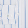 View 4 of product The Colony Blue Track Stripe Mayfair Shirt by Turnbull & Asser is a long-sleeve, button-up Italian cotton shirt with a white base and blue stripes, pointed collar, and buttoned cuffs, shown laid flat on a white background.