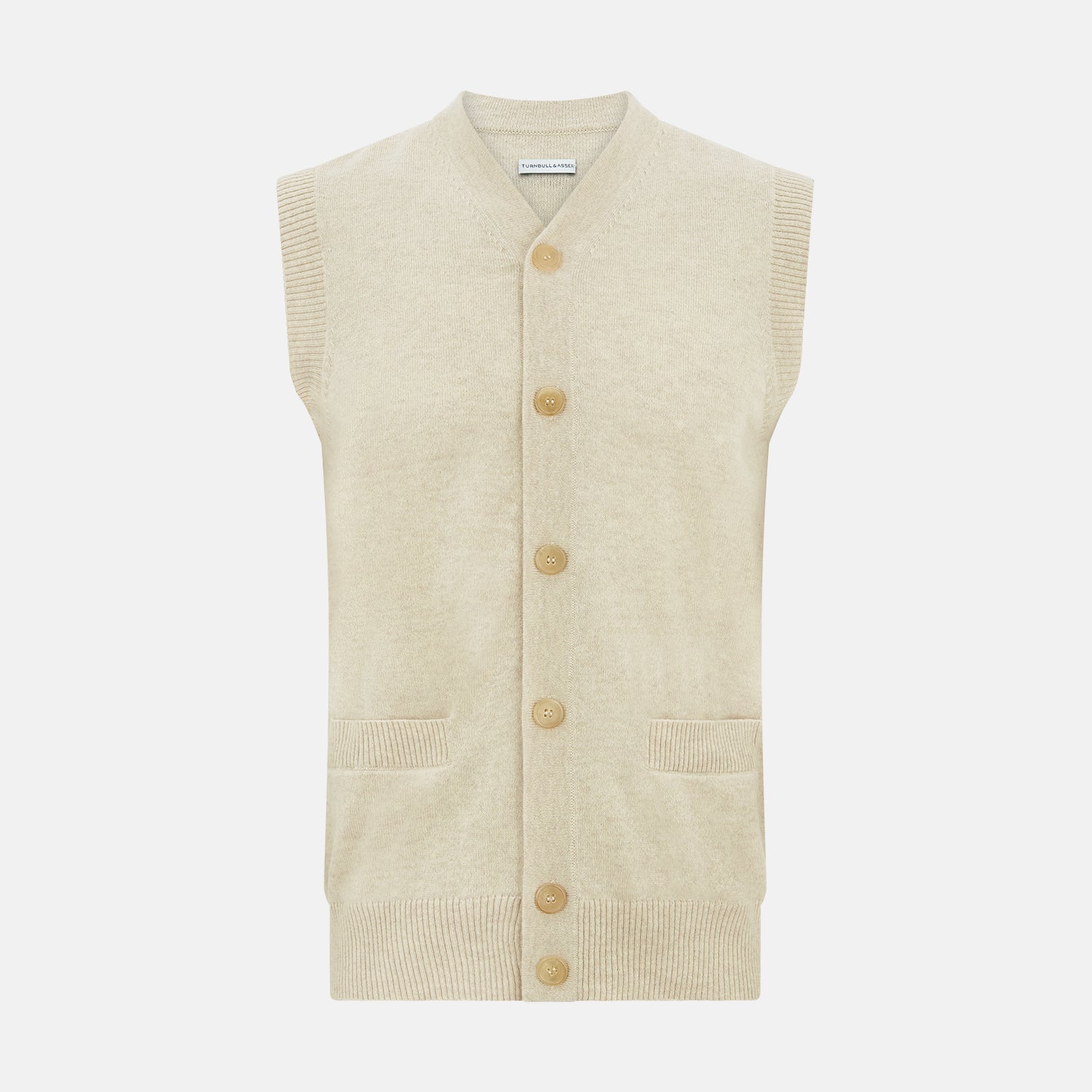 View 1 of product Turnbull & Asser’s Ivory Cashmere Sleeveless Cardigan features a button-down front, two small pockets, and ribbed trim at the hem, armholes, and collar—ideal for elegant looks. Shown on a white background.