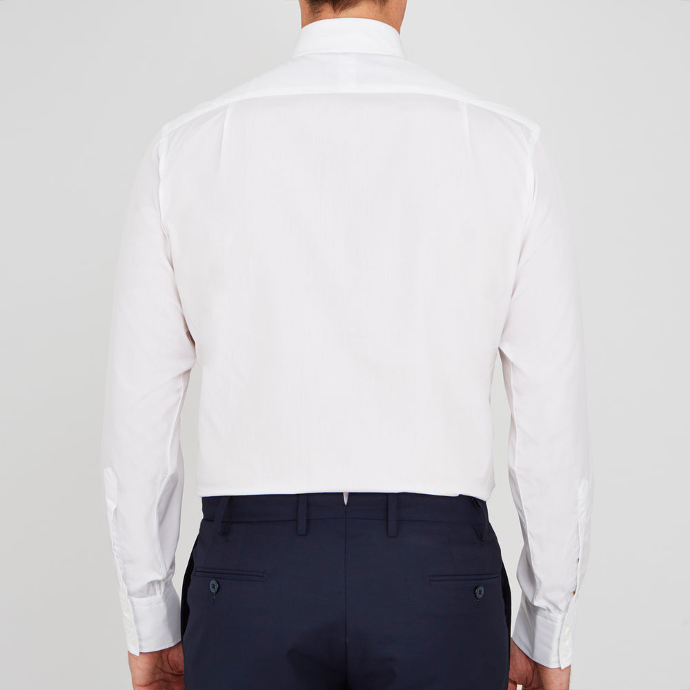 A neatly folded Turnbull & Asser Two-Fold 200 White Cotton Shirt with a Regent collar and 3-button cuffs, crafted from breathable fabric, is displayed on a light grey background with the label visible inside the collar.