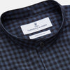 View 2 of product The Turnbull & Asser Navy Check Cotton Weekend Fit Blake Shirt features a long-sleeve, button-up design with a stand collar and white buttons, shown on a white background.