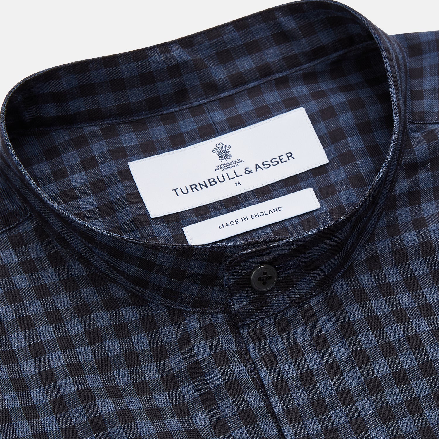 View 2 of product The Turnbull & Asser Navy Check Cotton Weekend Fit Blake Shirt features a long-sleeve, button-up design with a stand collar and white buttons, shown on a white background.