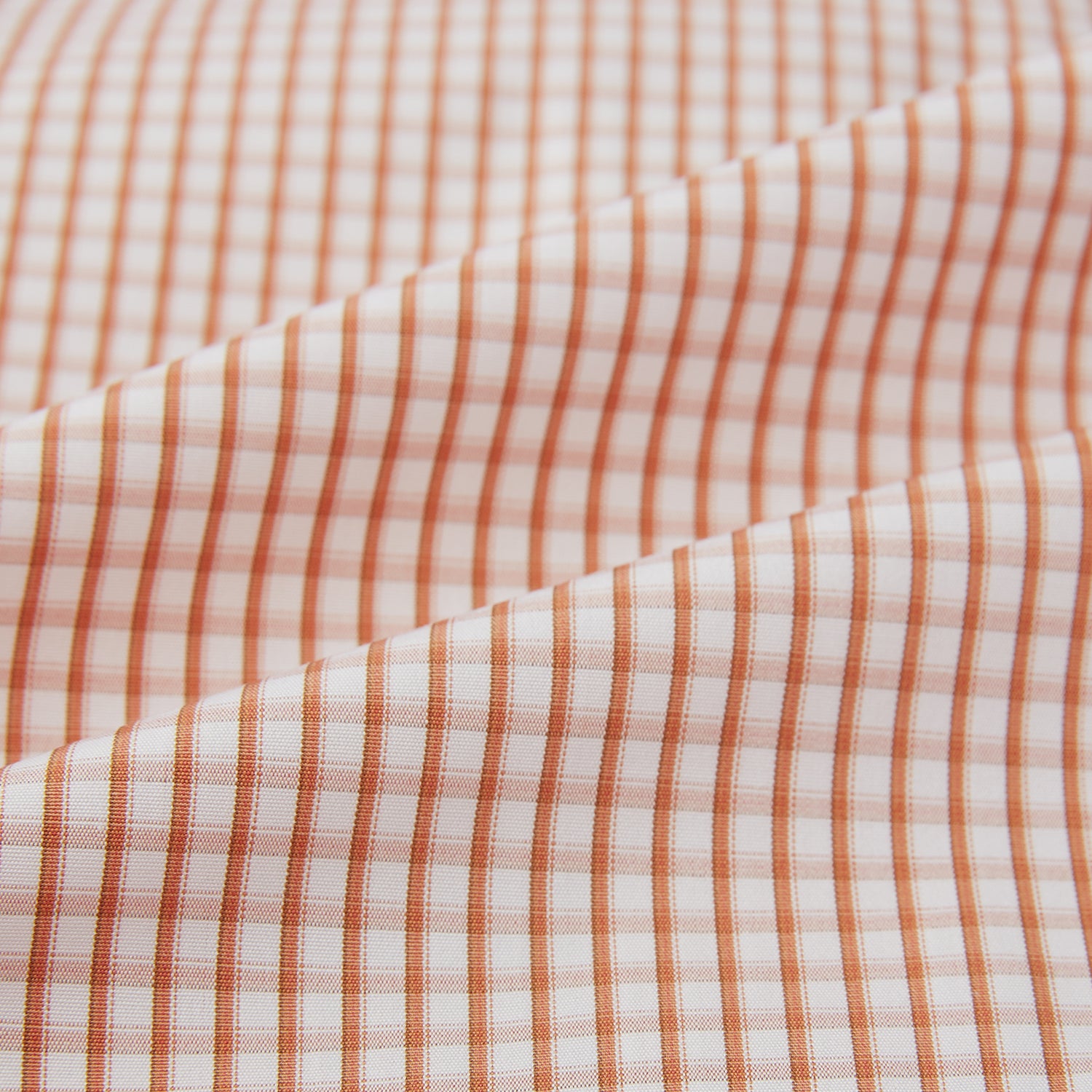 View 6 of product The Orange Micro Shadow Check Mayfair Shirt by Turnbull & Asser features a T&A collar, button-down front, and buttoned cuffs; crafted from Italian cotton in an orange and white check pattern, laid flat on a white background.