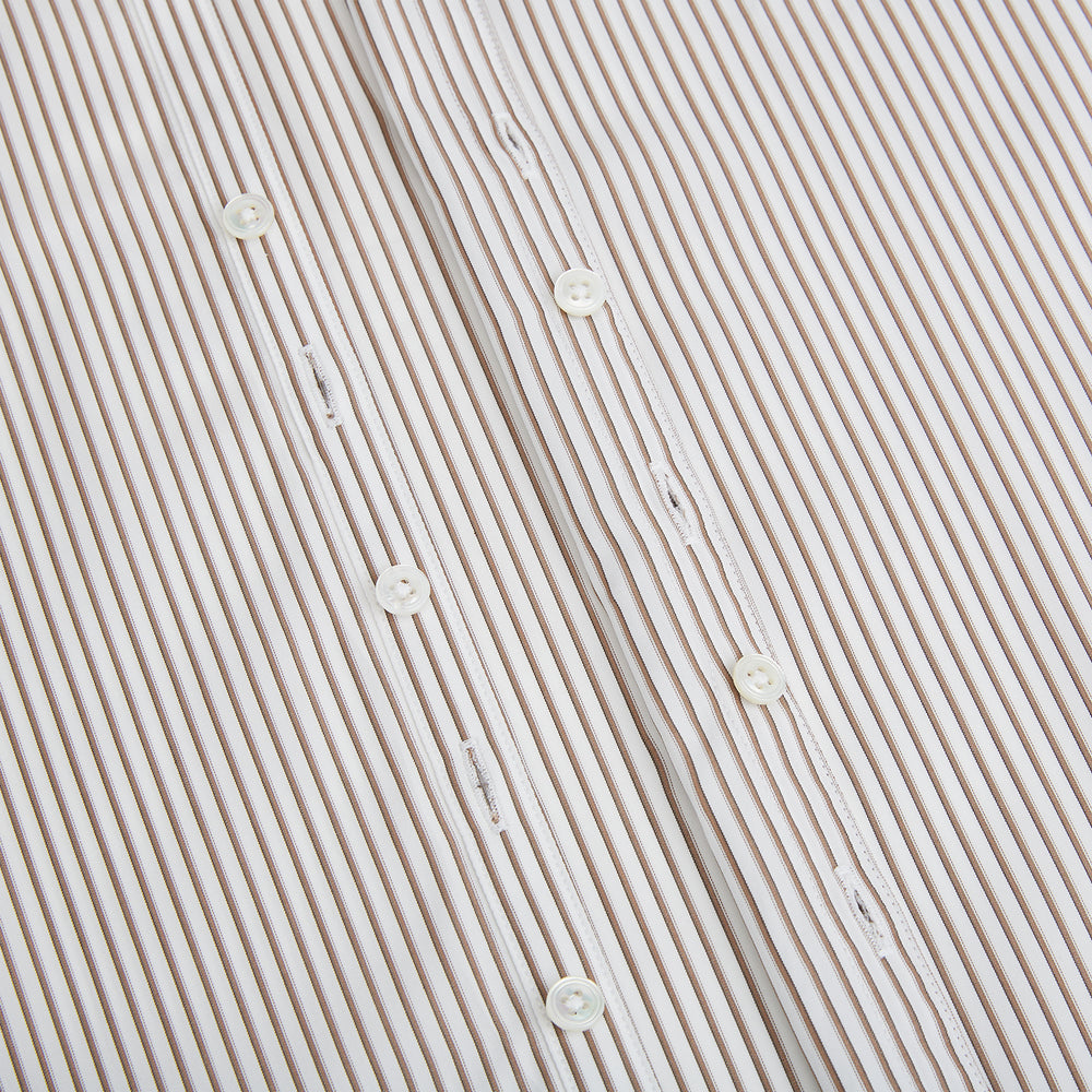 The Turnbull & Asser Coffee Multi Stripe Westminster Shirt features long sleeves, a button-up front, subtle beige and white stripes, a pointed Turnbull collar, and buttoned cuffs—expertly crafted in Britain and shown flat on a white background.