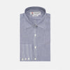 View 1 of product The Turnbull & Asser Navy and White Bengal Stripe Tailored Fit Shirt features blue and white vertical stripes, white buttons, and a streamlined silhouette, shown neatly folded against a plain white background.
