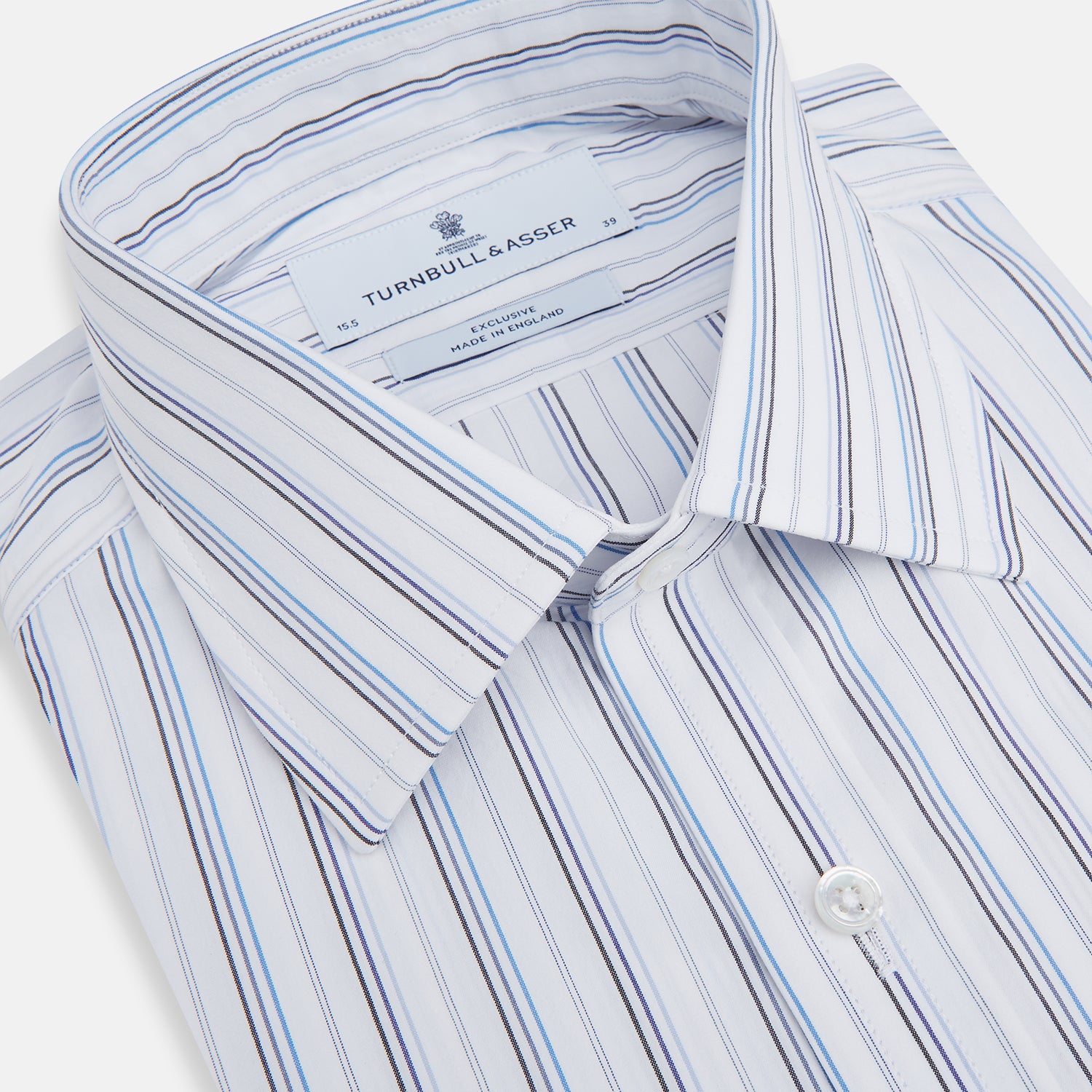 View 2 of product The Turnbull & Asser Blue Fine Multi Pinstripe Mayfair Shirt features long sleeves, an organic cotton build, a T&A collar, and vertical blue stripes. Laid neatly on a white background.