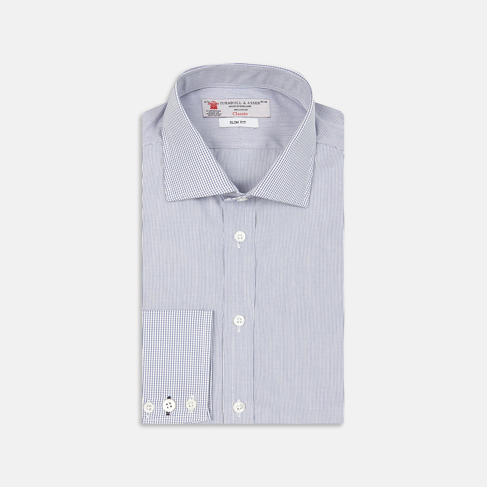 The Turnbull & Asser Slim Fit Blue Checked Shirt features long sleeves, contrasting white buttons, a regent collar, and distinct blue check pattern detailing on the cuff.