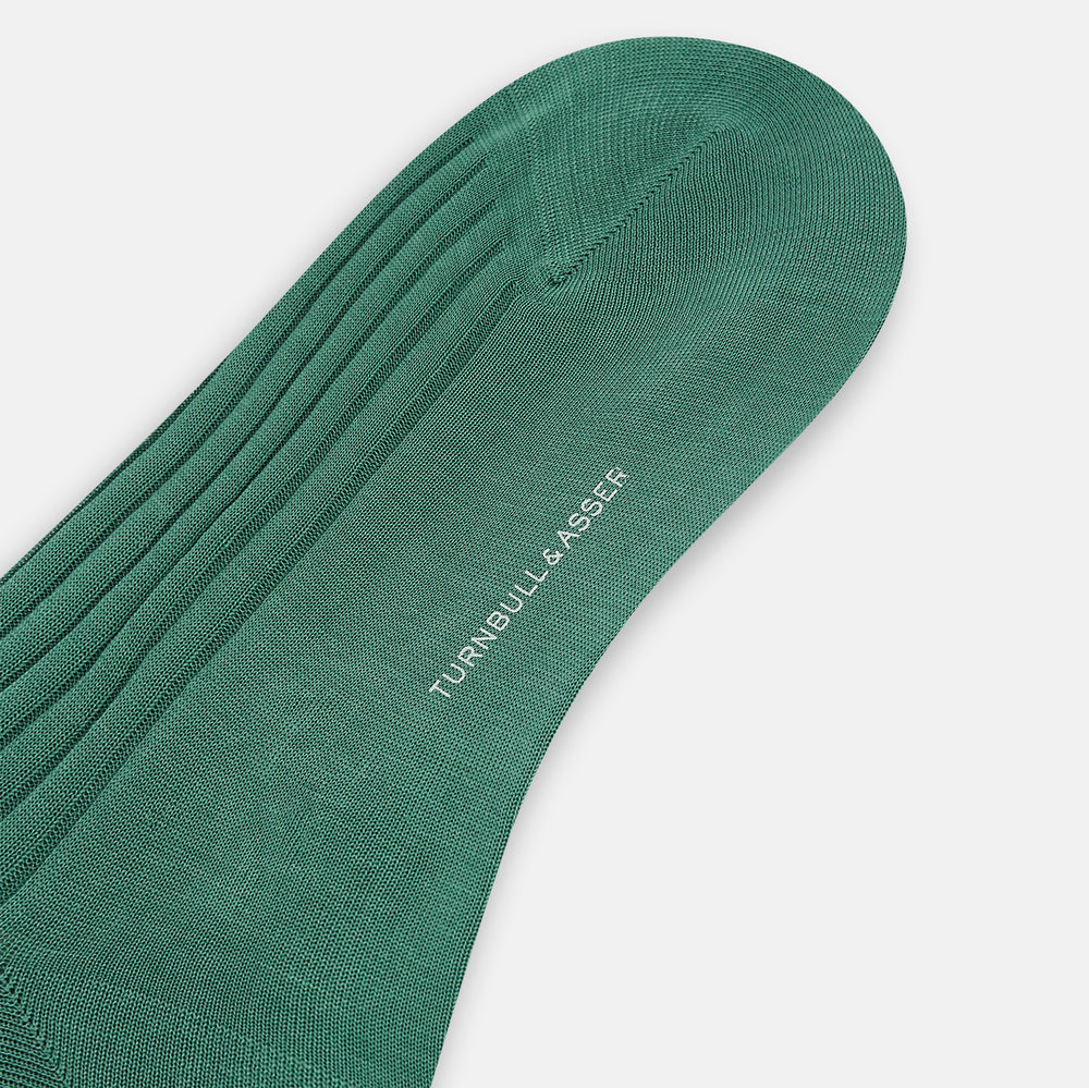 The Turnbull & Asser Sage Mid-Length Sock is shown angled on a white background, emphasizing its ribbed texture and length—a refined, comfortable sock designed for style.