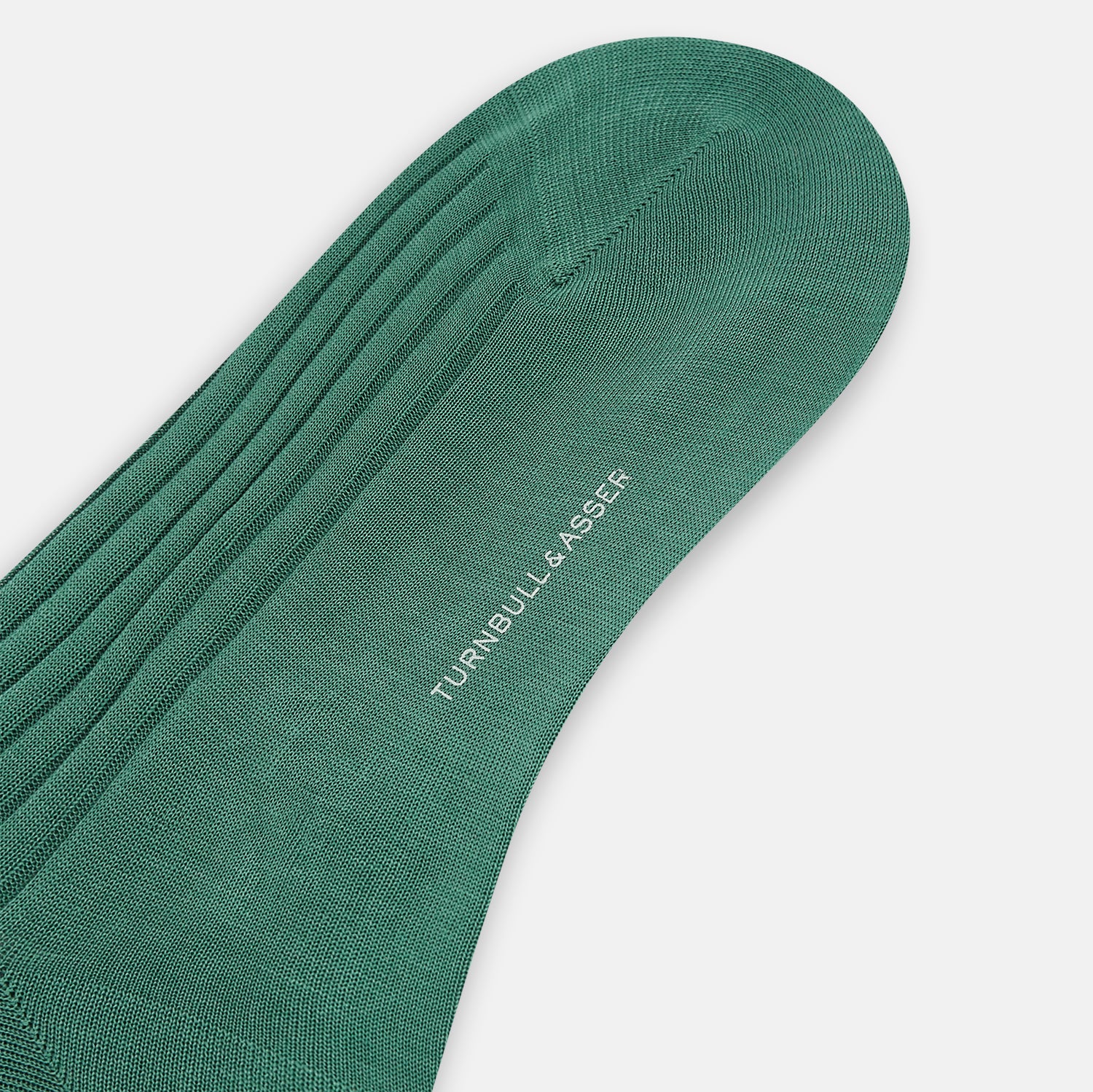 View 4 of product The Turnbull & Asser Sage Mid-Length Sock is shown angled on a white background, emphasizing its ribbed texture and length—a refined, comfortable sock designed for style.