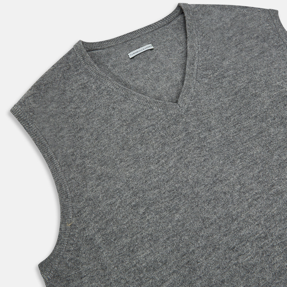 Turnbull & Asser's Grey Melange V-neck Cashmere Vest features classic ribbed trim at the neck, armholes, and hem—an elegant addition to any gentleman’s wardrobe, shown here against a plain white background.